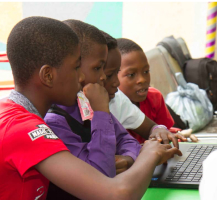 4 children with a laptop